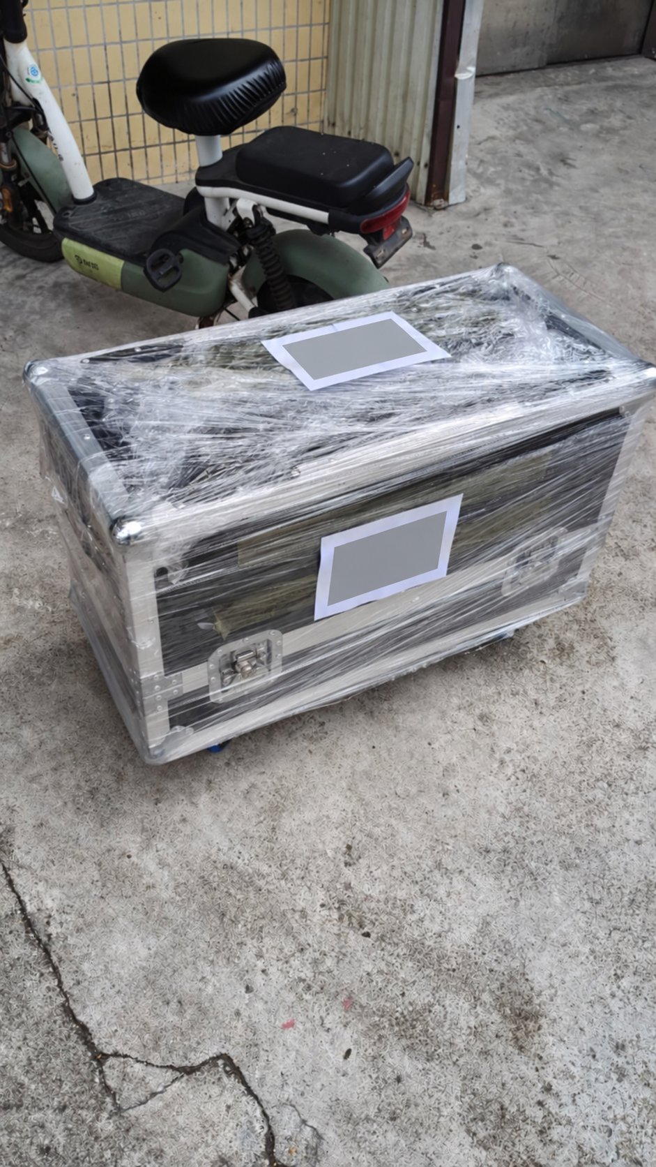 Wrapped flight case prepared for the customer's nominated freight forwarder; shipping labels obscured